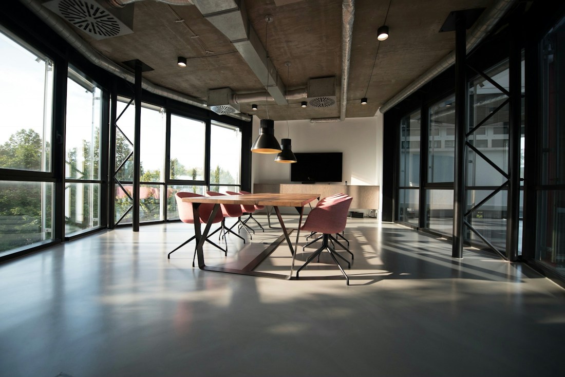 Open, plant-filled contemporary workspace with large windows
